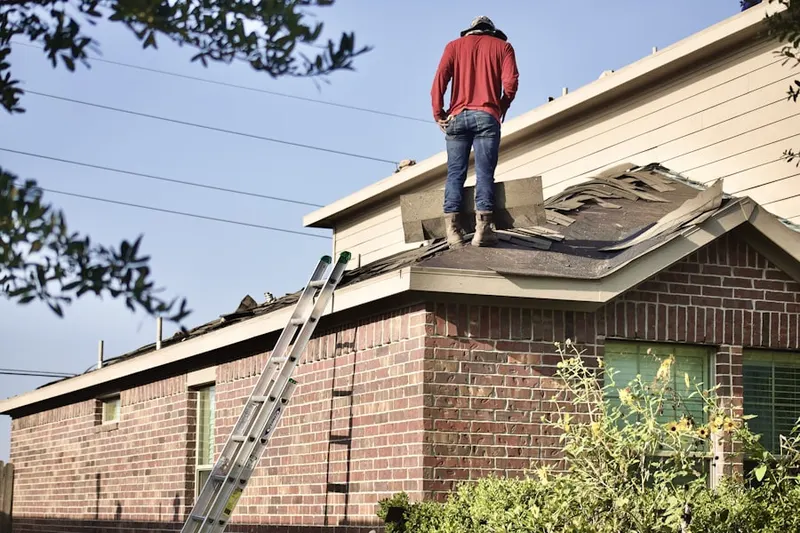 Professional roofer working on a residential roof in Geneva